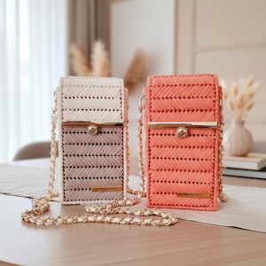 May include: Two rectangular crossbody bags with a woven chevron pattern and gold-tone chain straps. One bag features a cream top and light brown bottom, while the other is solid coral. Both have a gold metal clasp and a small rectangular logo plate.