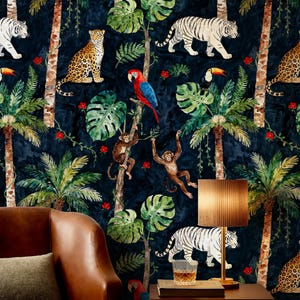 May include: Dark blue wallpaper with a jungle theme featuring tigers, leopards, monkeys, parrots, and palm trees. The design includes red flowers and lush green foliage. A brown leather armchair and a table with a lamp are in the foreground.