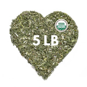 May include: A heart-shaped pile of dried green herbs with a white text overlay reading 5 LB and a circular green and white USDA Organic seal. The texture consists of small, fragmented leaves and stems in various shades of light and dark green.