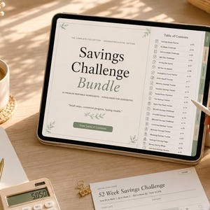 May include: A digital tablet displays a "Savings Challenge Bundle" with a table of contents. A notebook, calculator, and coffee cup are on the table. A person is using a stylus to navigate the tablet. The scene suggests financial planning and budgeting.