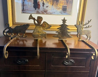 Set vintage di 4 portacalze a forma di silhouette in ottone massiccio con gancio curvo e braccio color oro.