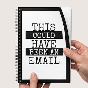May include: A spiral-bound notebook with a white cover featuring a thick black border and the black text THIS COULD HAVE BEEN AN EMAIL printed in a bold, typewriter-style font. The notebook has lined pages visible on the right side edge.