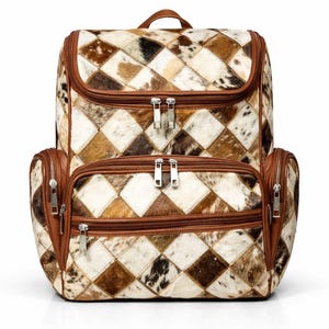 Puede incluir: Mochila de patchwork con estampado de diamantes en tonos marrones, beige y blanco. Cuenta con ribetes de cuero marrón, dos compartimentos delanteros con cremallera y un asa superior. Las cremalleras son plateadas.