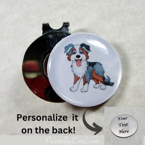 May include: A silver golf ball marker with a cartoon image of an Australian Shepherd dog on the front. The back of the marker is blank and can be personalized with text. "Your Text Here" is shown on a separate image.