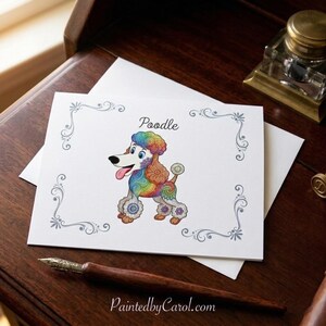 May include: A white rectangular greeting card featuring a colorful, patterned illustration of a poodle dog with the word Poodle printed above it. The card has a decorative gray filigree border and the text PaintedbyCarol.com printed at the bottom.