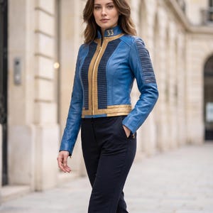 May include: A blue and gold leather jacket featuring a high collar with the number 33 printed in gold, a central gold zipper, ribbed detailing on the chest and shoulders, and long sleeves, paired with solid black trousers.