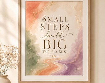 May include: A framed art print with the text "SMALL STEPS build BIG DREAMS." The artwork features a watercolor design with orange, green, and purple hues. The print is in a light brown wooden frame.