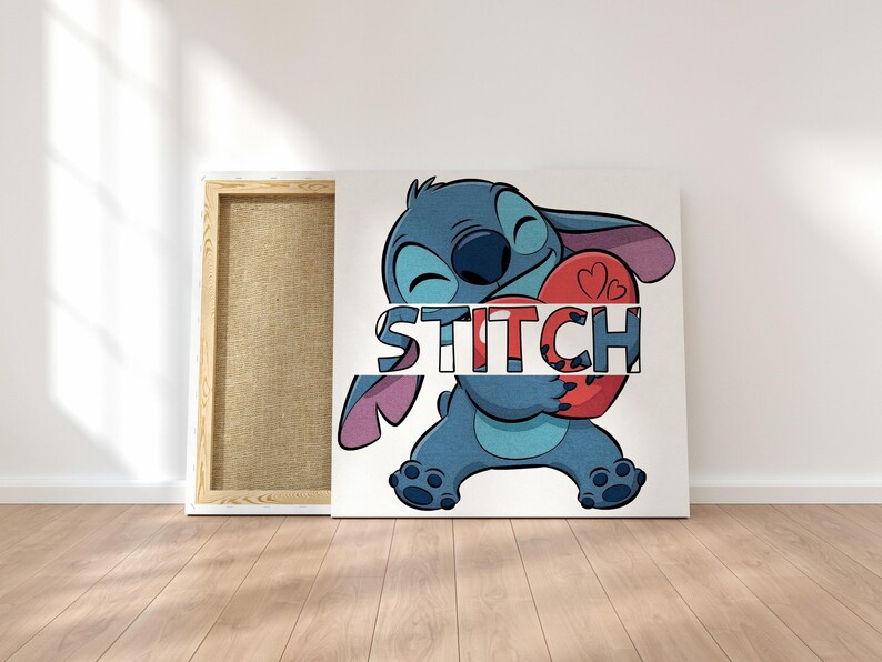 May include: A canvas art print featuring the character Stitch from Lilo & Stitch. Stitch, in shades of blue, is holding a red heart with the word "STITCH" across it. The canvas is displayed on a white wall with a wooden frame.