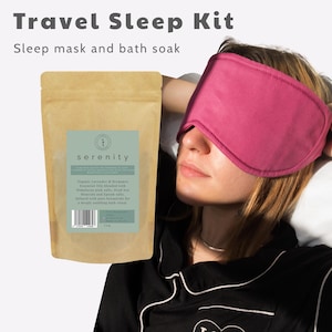 May include: A travel sleep kit comprising a pink sleep mask and a bag of bath soak. The bag is tan with a green label reading "serenity" and listing ingredients. The text "Travel Sleep Kit" and "Sleep mask and bath soak" are at the top.
