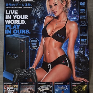 May include: A promotional PlayStation 2 poster featuring a black console, a controller, and game covers including Grand Theft Auto, God of War, Need for Speed, Final Fantasy, and Metal Gear Solid 3. The text reads Live in your world. Play in ours.