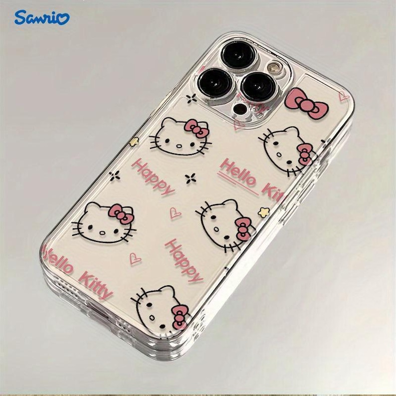 May include: Clear phone case featuring a repeating pattern of Hello Kitty faces with pink bows, the word "Happy", and the words "Hello Kitty". The case has a clear border and is designed to fit a smartphone.