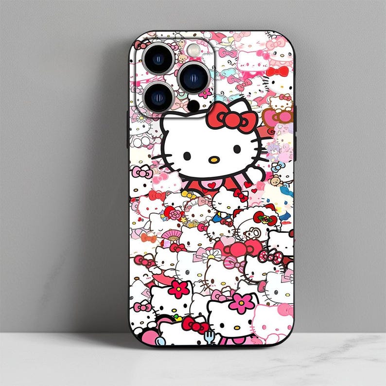 May include: A black phone case with a colorful pattern of Hello Kitty characters. The case features a white Hello Kitty with a red bow and a pink background.