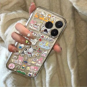 May include: Clear phone case decorated with colorful cartoon character stickers. The case has a clear back and a transparent border. The stickers feature various characters and designs, including Hello Kitty and My Melody.
