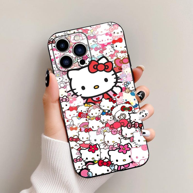 May include: A white iPhone case with a Hello Kitty design. The case is covered in Hello Kitty characters, bows, and hearts. The case has a black camera lens cutout.