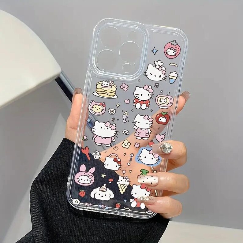 May include: Clear phone case featuring a colorful design with multiple Hello Kitty illustrations and food-themed graphics. The case has a transparent background and is decorated with various images, including strawberries, ice cream, and cakes.