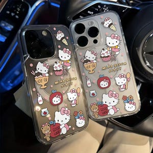 May include: Two clear phone cases with a cartoon design of Hello Kitty characters, ice cream, cupcakes, and apples. The cases have pink polka dots and the text "Mint Green Kitty" and "Good Luck".