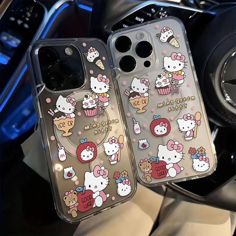 May include: Two clear phone cases with a cartoon design of Hello Kitty characters, ice cream, cupcakes, and apples. The cases have pink polka dots and the text "Mint Green Kitty" and "Good Luck".