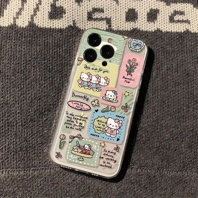 May include: Clear phone case with colorful stickers featuring cartoon characters, flowers, and text. The stickers include phrases like "Best wish for you," "Beautiful Tulip," and "Happy." The case has a multi-camera design.