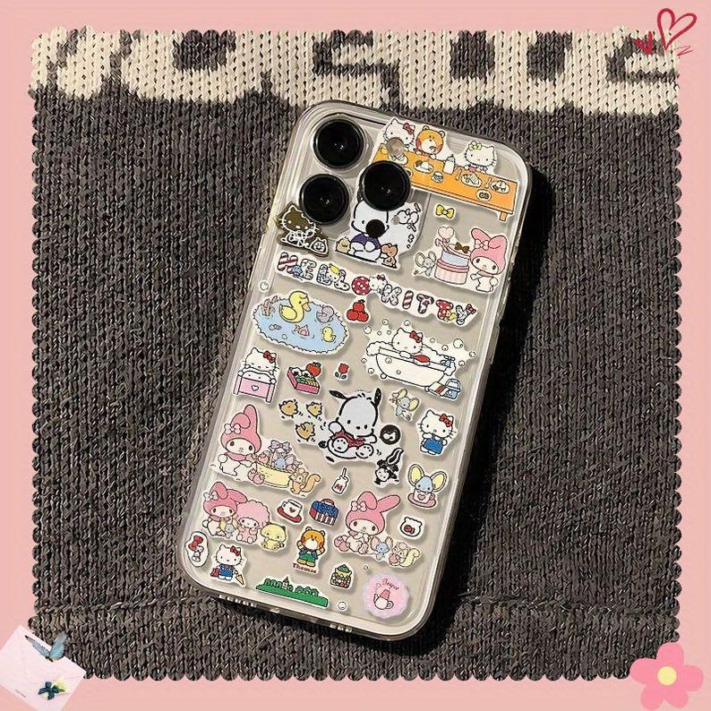 May include: Clear phone case decorated with colorful cartoon character stickers. The stickers feature various characters and scenes, including Hello Kitty, My Melody, and other Sanrio characters. The case has a clear background and a protective design.