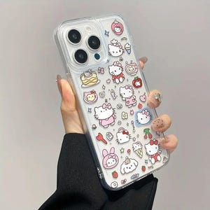 May include: Clear phone case featuring a repeating pattern of cartoon characters, including a cat with a bow, strawberries, and desserts. The case is designed to fit a smartphone.