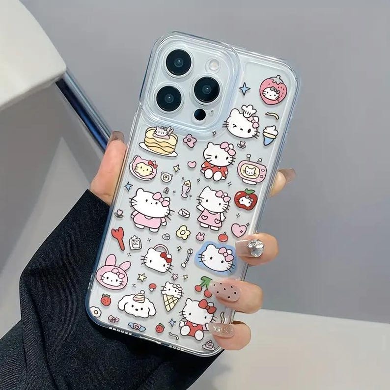 May include: Clear phone case with a variety of colorful Hello Kitty character graphics. The case features multiple images of Hello Kitty in different outfits, along with other cute illustrations like desserts and flowers.