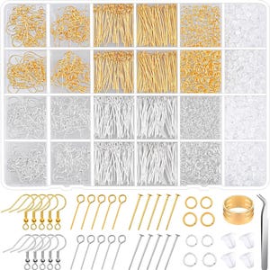 May include: A clear plastic organizer box filled with jewelry making supplies including gold and silver earring hooks, head pins, eye pins, jump rings, and clear earring backs, with additional loose components and tweezers displayed below.