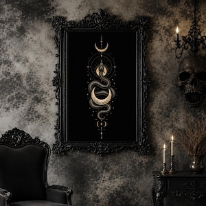 May include: Black framed wall art featuring a detailed illustration of a snake intertwined with crescent moons and celestial elements. The artwork is in gold and white against a black background. The frame is ornate and black, adding to the gothic aesthetic.