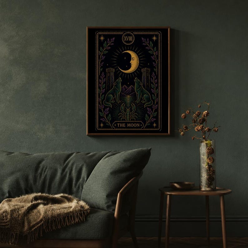 May include: A framed tarot card print featuring a crescent moon, two wolves, and the text "THE MOON." The artwork is in shades of black, gold, green, and purple. The print is displayed on a dark green wall above a green sofa.