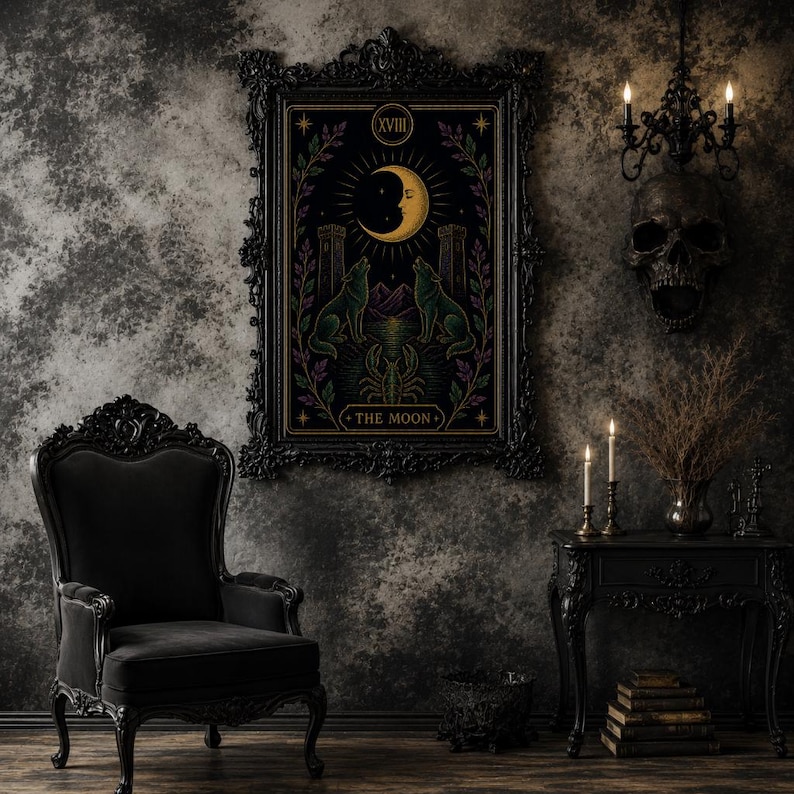 May include: A framed tarot card print featuring a crescent moon, two wolves, and the text "THE MOON." The artwork is in a black ornate frame, with a dark, gothic aesthetic. The room includes a black chair, side table, and skull decor.