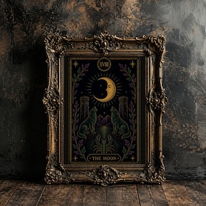May include: A framed tarot card print featuring a crescent moon, two howling wolves, and the text "THE MOON." The artwork is in a decorative gold frame. The color palette includes black, gold, green, and purple.