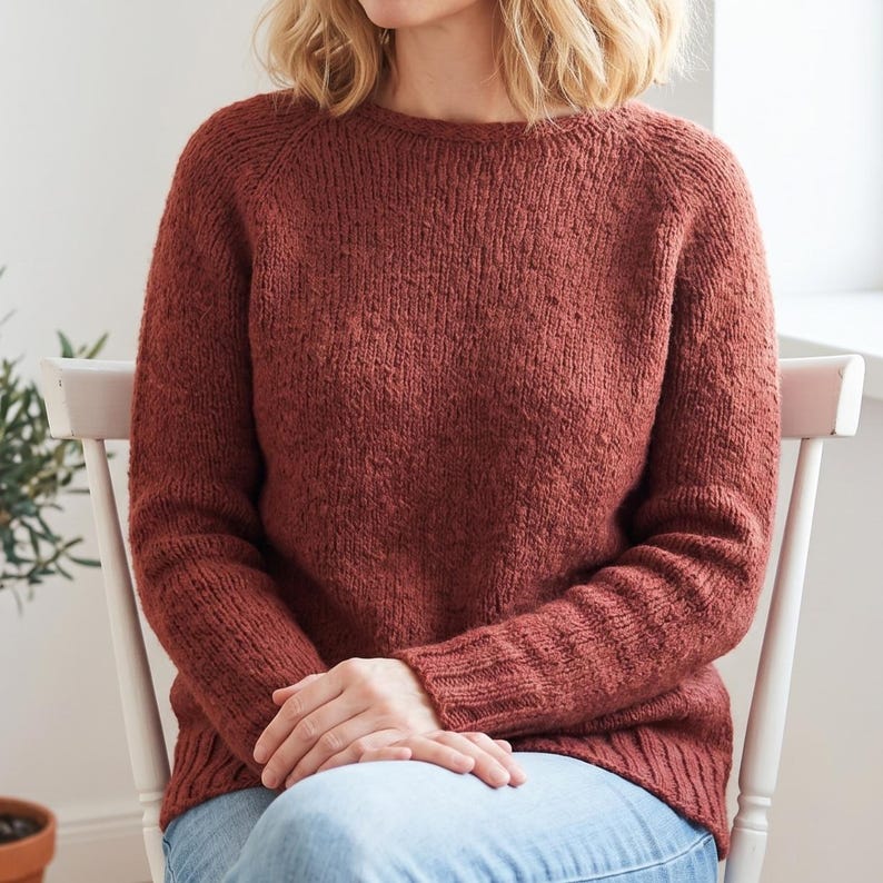 basic knitted raglan sweater beige minimal style
top down seamless knit sweater classic design
close up stockinette knit texture soft yarn detail
woman wearing simple knit sweater everyday outfit
handmade knitted pullover neutral cozy look