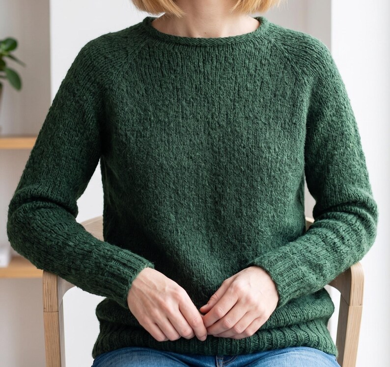 basic knitted raglan sweater beige minimal style
top down seamless knit sweater classic design
close up stockinette knit texture soft yarn detail
woman wearing simple knit sweater everyday outfit
handmade knitted pullover neutral cozy look