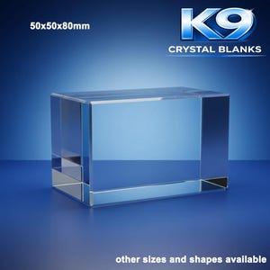 May include: A clear, rectangular crystal block, 50mm x 50mm x 80mm, with beveled edges. The image includes the text "K9 CRYSTAL BLANKS" and "other sizes and shapes available" on a gradient blue background.