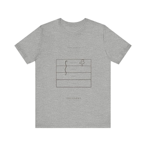 May include: Grey t-shirt with a minimalist graphic. The design includes a rectangle with horizontal lines, a curved line, and a flower. The word "THURSDAY" is printed below the graphic in a simple font.