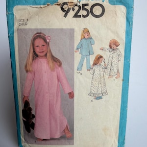 May include: A vintage Simplicity sewing pattern for a child's size 3. The pattern features a pink nightgown and pajama set. The package is blue and white with the number 9250 and the word Simplicity.