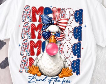 May include: White t-shirt featuring a cartoon duck with patriotic sunglasses and a bubblegum bubble. The word "America" is displayed in a repeating pattern with red, white, and blue accents. The phrase "Land of the free" is written at the bottom.