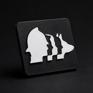 May include: A square black plaque featuring a white raised graphic design. The design displays a series of four silhouettes in profile, including a person wearing a helmet, two other human figures, and a dog, all arranged in a horizontal row.