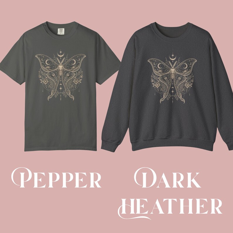 A pepper short-sleeved t-shirt and a dark heather long-sleeved sweatshirt, both printed with a gold and white moth design featuring crescent moons and floral details.
