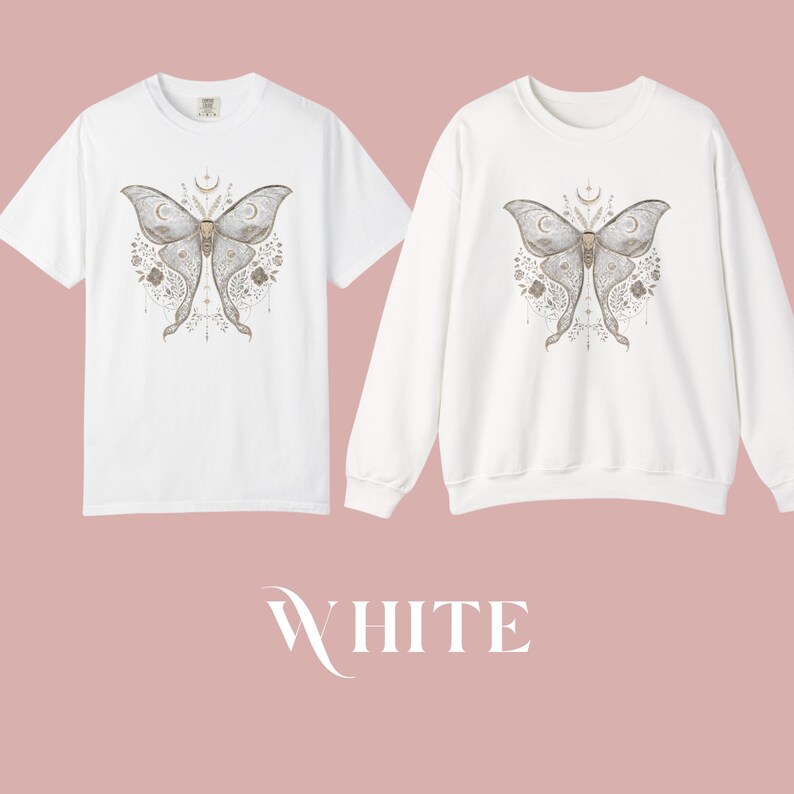 A white short-sleeved t-shirt and a white long-sleeved sweatshirt, both showcasing a gray and white moth design with crescent moons and floral motifs.