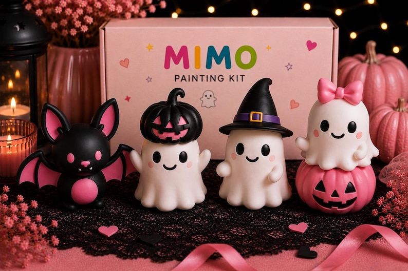 May include: A Mimo Painting Kit box featuring four small figurines: a black and pink bat, a white ghost with a black pumpkin hat, a white ghost wearing a black witch hat, and a white ghost with a pink bow sitting on a pink jack-o'-lantern.