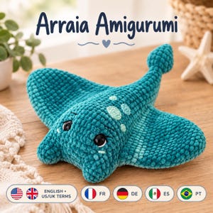 May include: A teal crochet stingray plush toy with a textured, soft yarn finish. The amigurumi features two black plastic eyes, light teal circular spots on its back, and a long tail. The text Arraia Amigurumi is displayed above the toy.