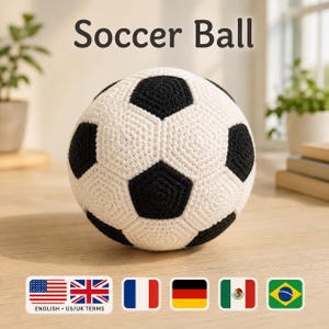 May include: A spherical soccer ball crafted with white and black yarn in a crochet pattern. The ball features the classic pentagonal and hexagonal panel design. The text Soccer Ball is printed in dark gray above the object in a simple font.