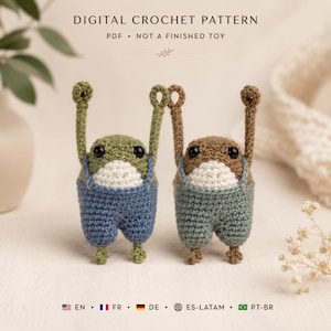 May include: Two crocheted frog figures with arms raised, one green and one brown, both wearing white bellies and blue or sage green overalls. Text reads: DIGITAL CROCHET PATTERN PDF NOT A FINISHED TOY. Includes language icons for EN, FR, DE, ES-LATAM, PT-BR.