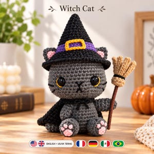 May include: A grey crocheted cat doll wearing a black witch hat with a purple band and yellow buckle, and a black cape. The cat has large black eyes, pink paw pads, and holds a small tan broomstick. The text Witch Cat is visible above the doll.