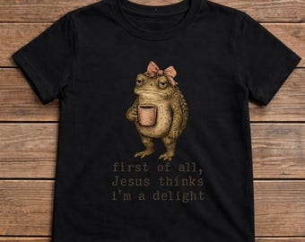 Camiseta con el meme de la rana "Primero que nada, Jesús piensa que soy una delicia", regalo para amantes de las ranas cristianos, camiseta gráfica con meme religioso divertido.