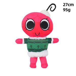 May include: A red ornament-shaped plush toy with large black eyes and a small smile. It wears a green sweater with white trim and has pink arms and legs. The toy is 27 cm tall and weighs 95g.