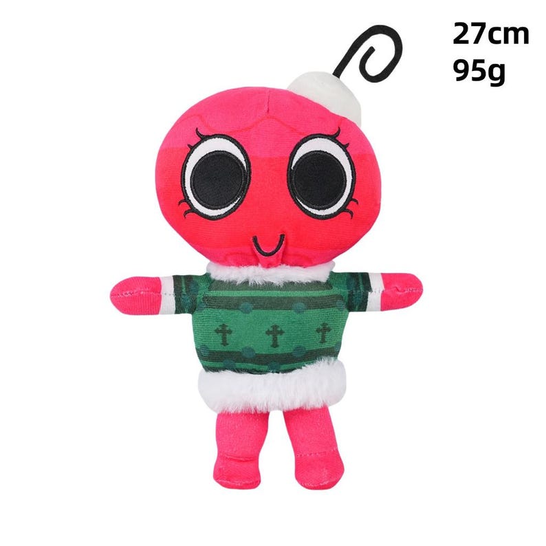 May include: A red ornament-shaped plush toy with large black eyes and a small smile. It wears a green sweater with white trim and has pink arms and legs. The toy is 27 cm tall and weighs 95g.