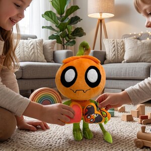 May include: An orange plush toy with large white eyes, a stitched mouth, and green limbs. The toy has a heart-shaped chest and a small pouch with a butterfly design. The toy is being held by two children.