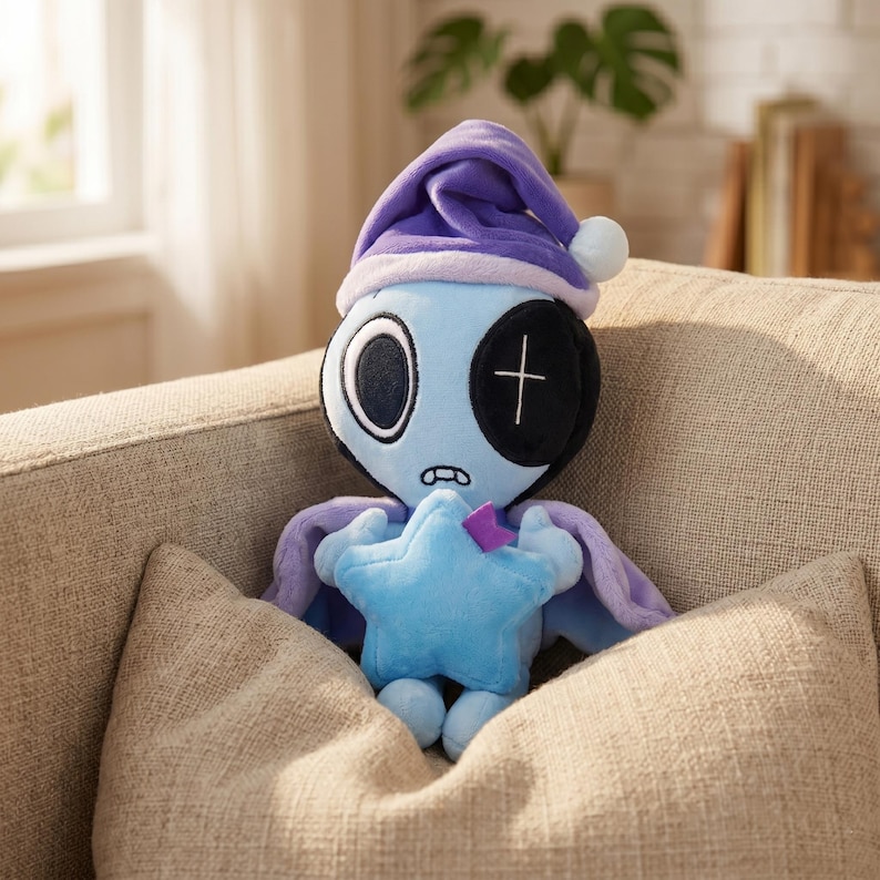 May include: A plush doll with a blue body, wearing a purple nightcap and cape, and holding a blue star. The doll has one large eye, a black patch over the other, and a stitched mouth. It is resting on a beige pillow.