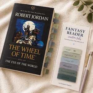 May include: A copy of "The Wheel of Time: The Eye of the World" book with attached page tabs. A pack of "Fantasy Reader" reaction tabs and a pen are next to the book. The book cover features a fantasy illustration.